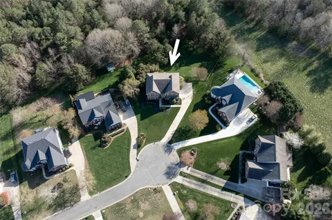 an aerial view of a house with a swimming pool
