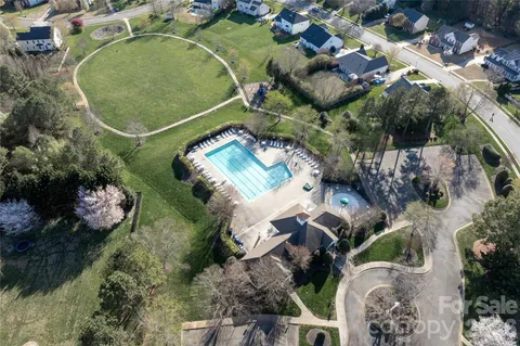 an aerial view of a house a yard and outdoor seating
