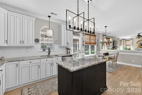 a kitchen with center island and stainless steel appliances
