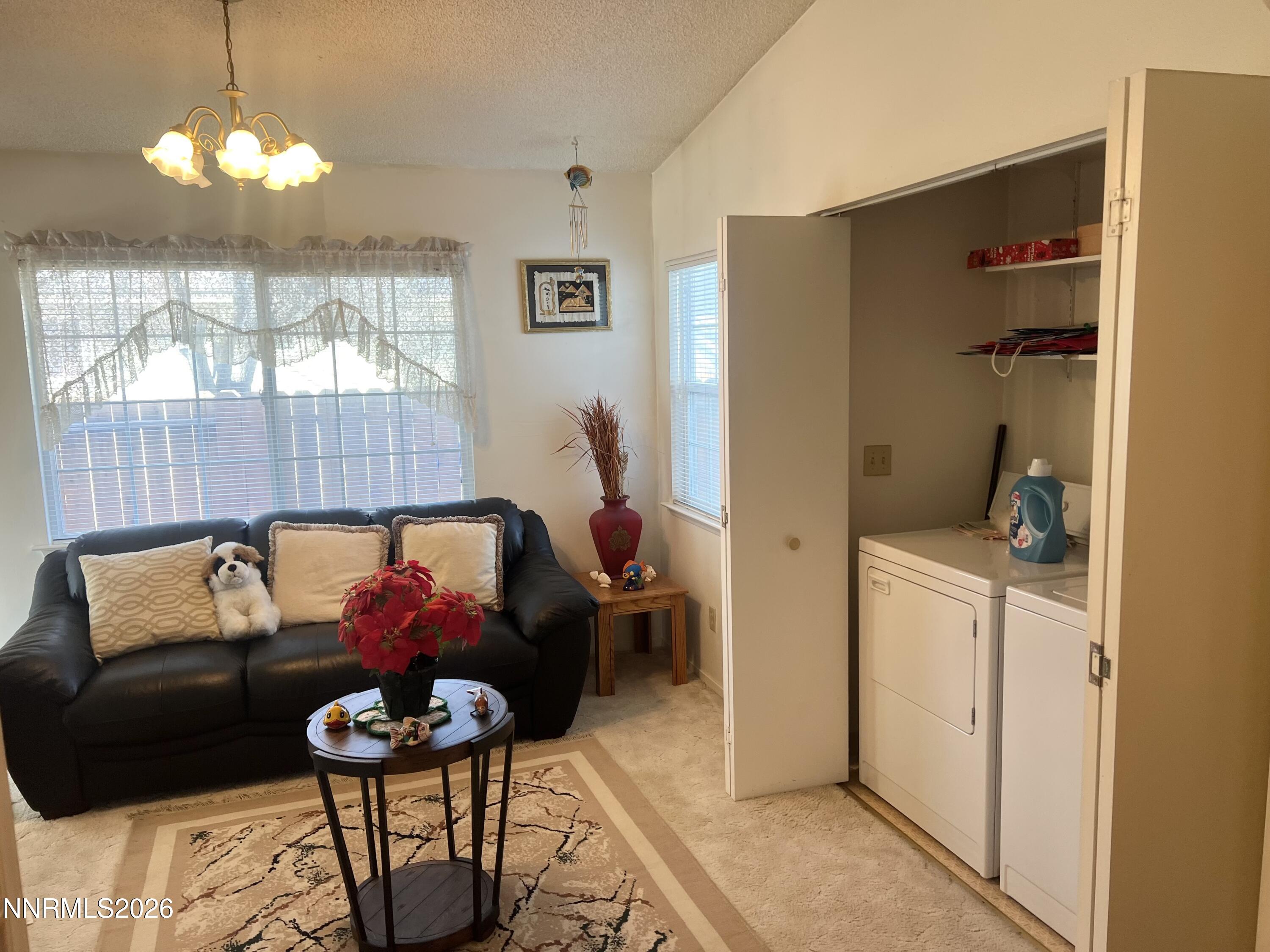 4330 Valdez Way Reno, NV 89502 - Photo 11 of 35 a living room with furniture and a chandelier