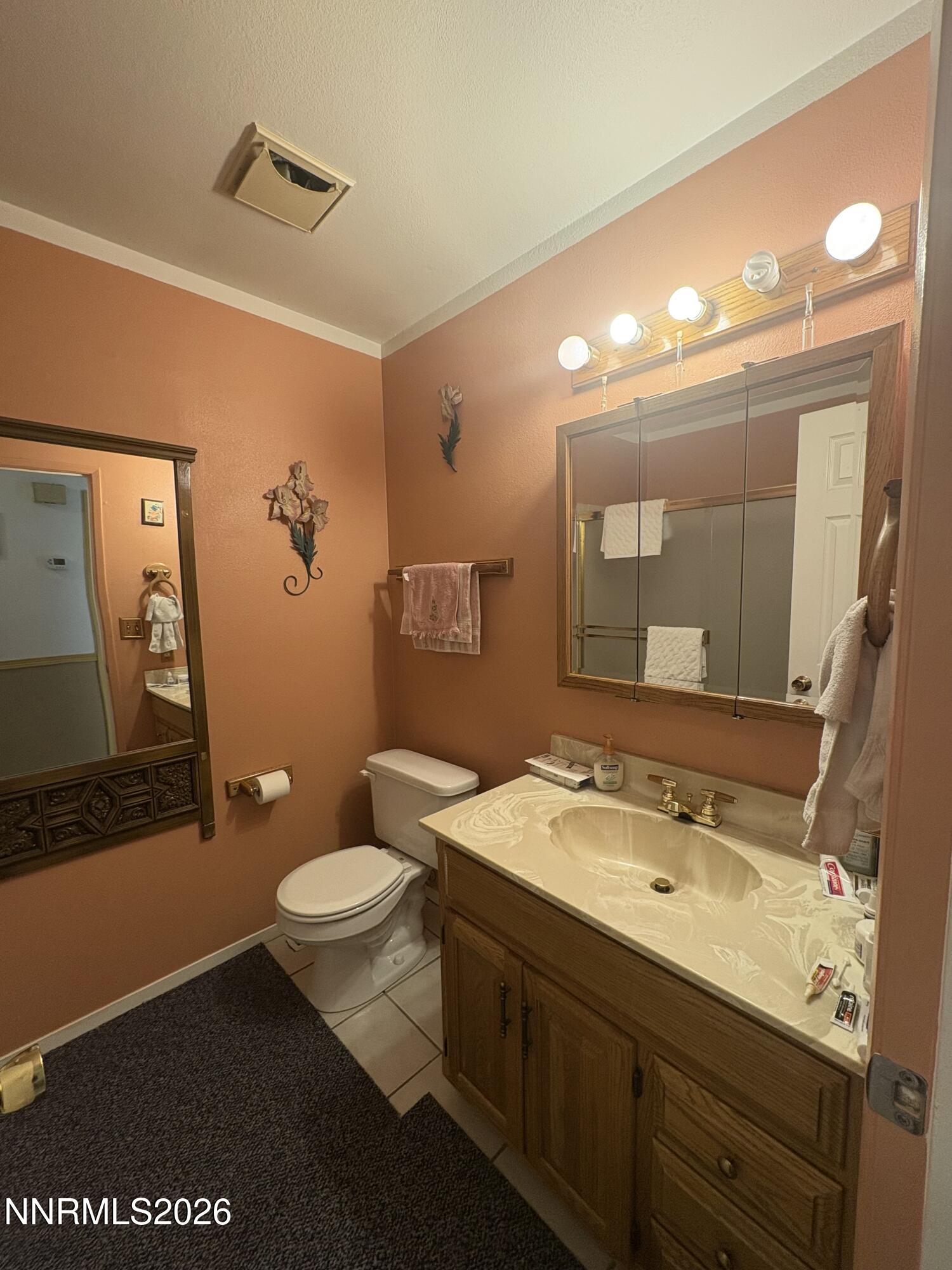 4330 Valdez Way Reno, NV 89502 - Photo 23 of 35 a bathroom with a toilet sink and mirror