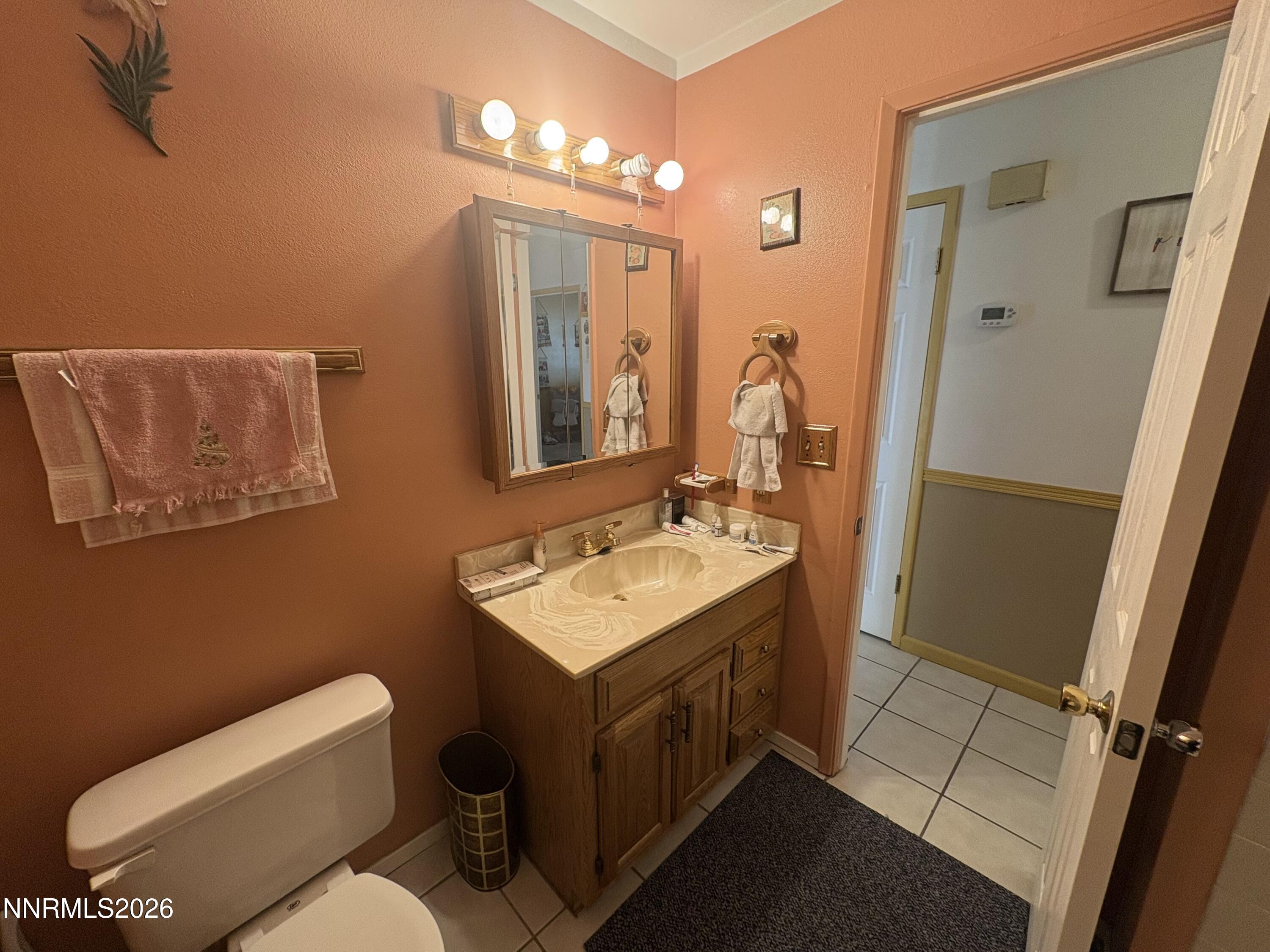 4330 Valdez Way Reno, NV 89502 - Photo 24 of 35 a bathroom with a toilet sink and mirror