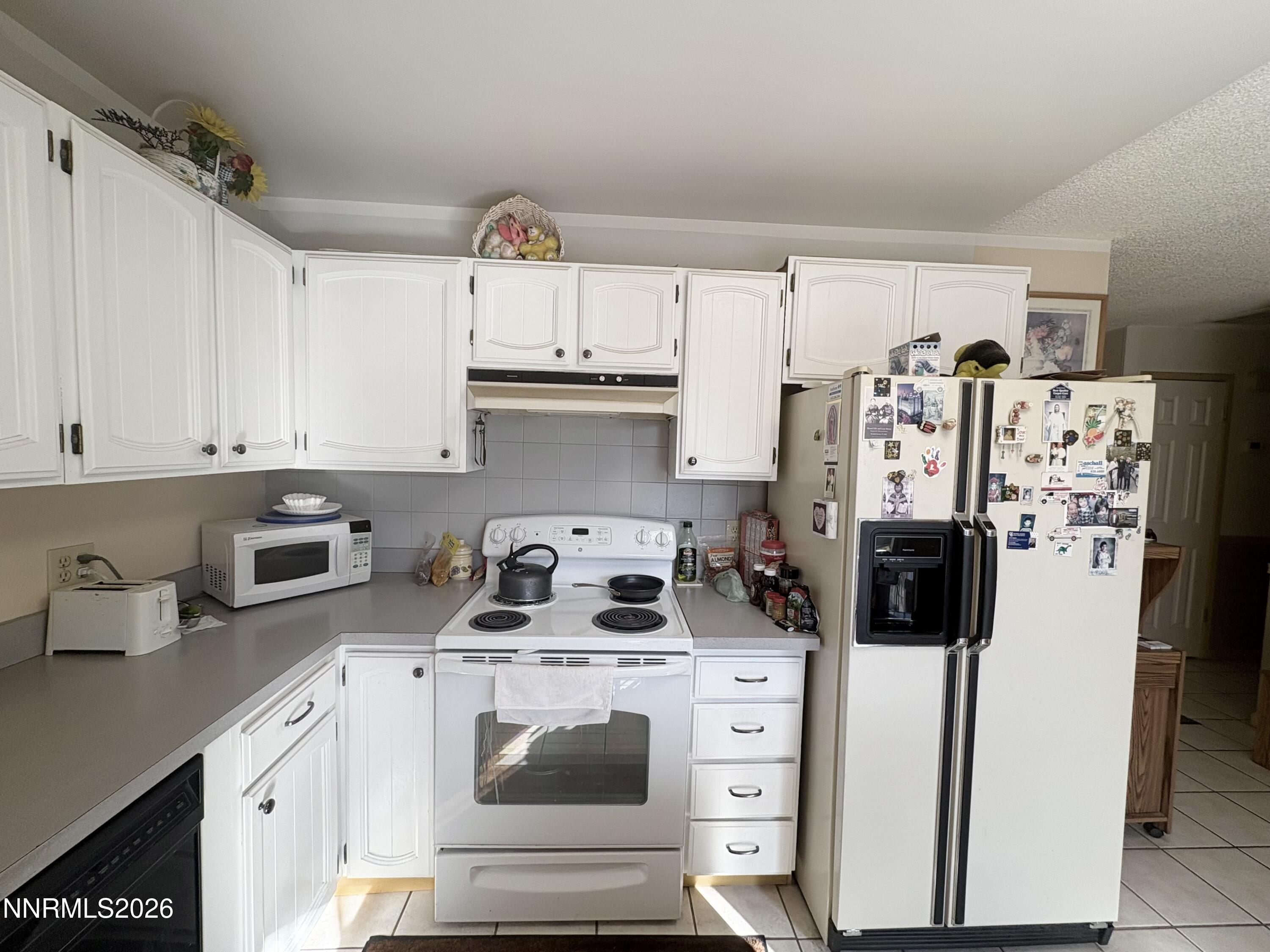 4330 Valdez Way Reno, NV 89502 - Photo 5 of 35 a kitchen with stainless steel appliances a refrigerator sink and cabinets