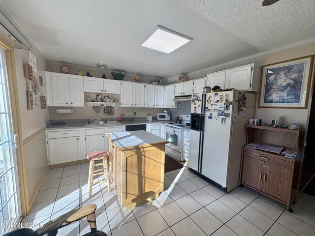 a kitchen with stainless steel appliances a stove a sink and a refrigerator