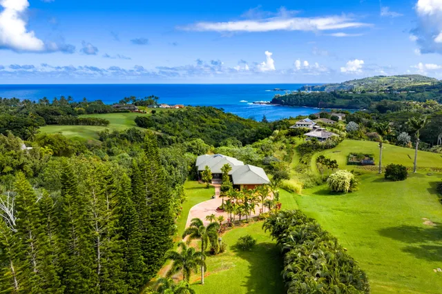 a bathroom with a toilet a sink a mirror and shower
