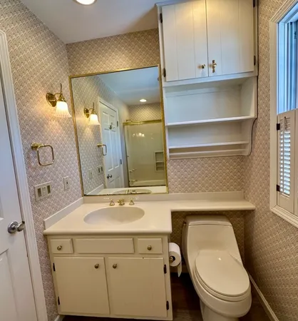 a bathroom with a granite countertop sink a large mirror and a bathtub