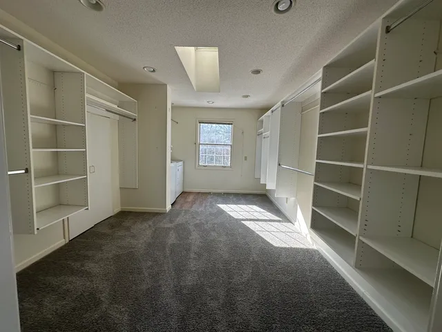 a kitchen with stainless steel appliances granite countertop wooden cabinets a sink and dishwasher with wooden floor