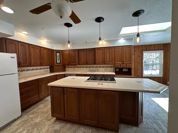 a kitchen with a stove a refrigerator and a sink