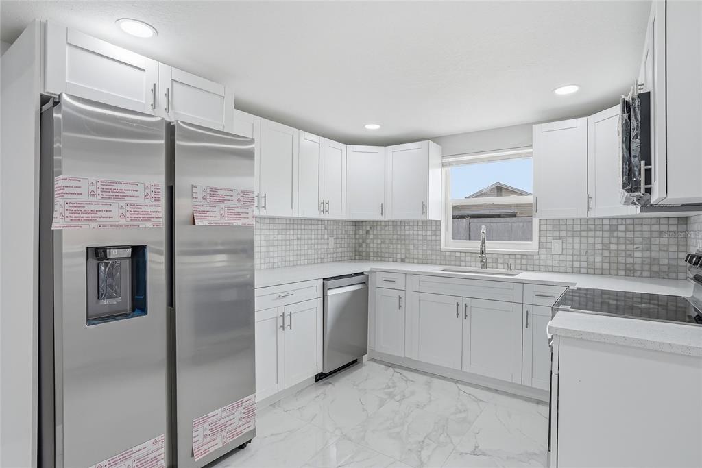 6302 Diamond Drive New Port Richey, FL 34653 - Photo 11 of 43 a kitchen with a sink stainless steel appliances and cabinets