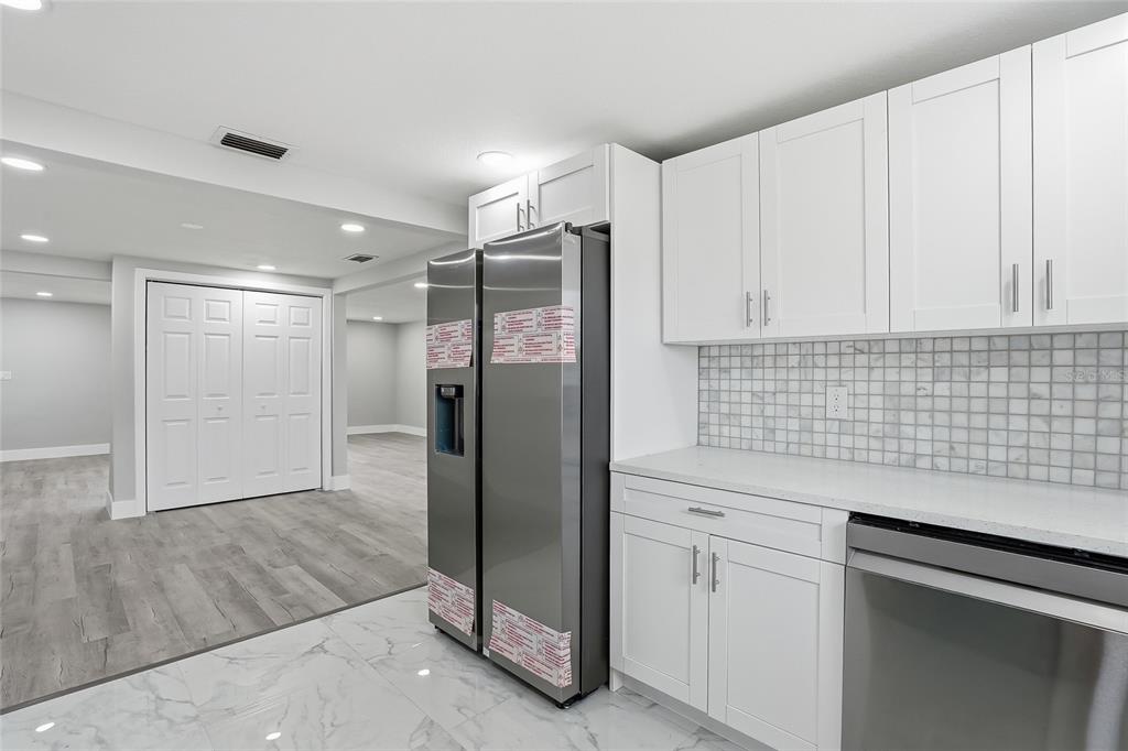 6302 Diamond Drive New Port Richey, FL 34653 - Photo 15 of 43 a kitchen with stainless steel appliances granite countertop a refrigerator and a sink