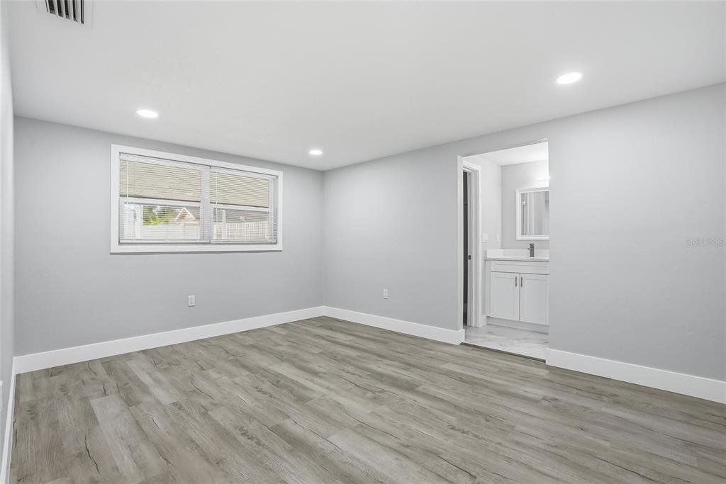 6302 Diamond Drive New Port Richey, FL 34653 - Photo 16 of 43 wooden floor in an empty room with a window