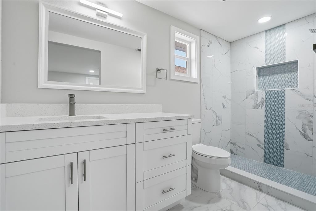 6302 Diamond Drive New Port Richey, FL 34653 - Photo 18 of 43 a bathroom with a sink a toilet and shower