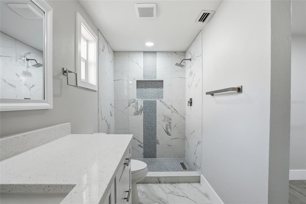 6302 Diamond Drive New Port Richey, FL 34653 - Photo 19 of 43 a bathroom with a sink toilet and shower