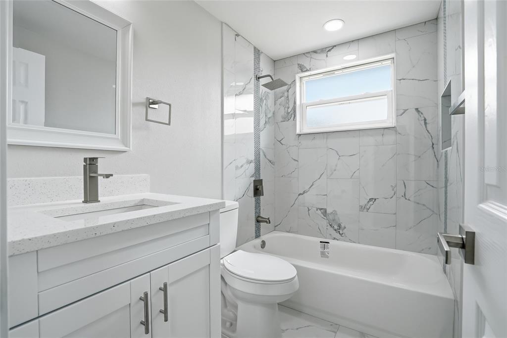 6302 Diamond Drive New Port Richey, FL 34653 - Photo 24 of 43 a bathroom with a sink a toilet and shower