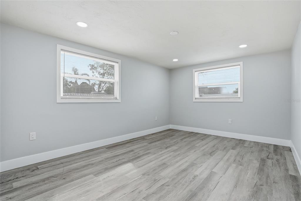 6302 Diamond Drive New Port Richey, FL 34653 - Photo 26 of 43 a view of an empty room with wooden floor and a window