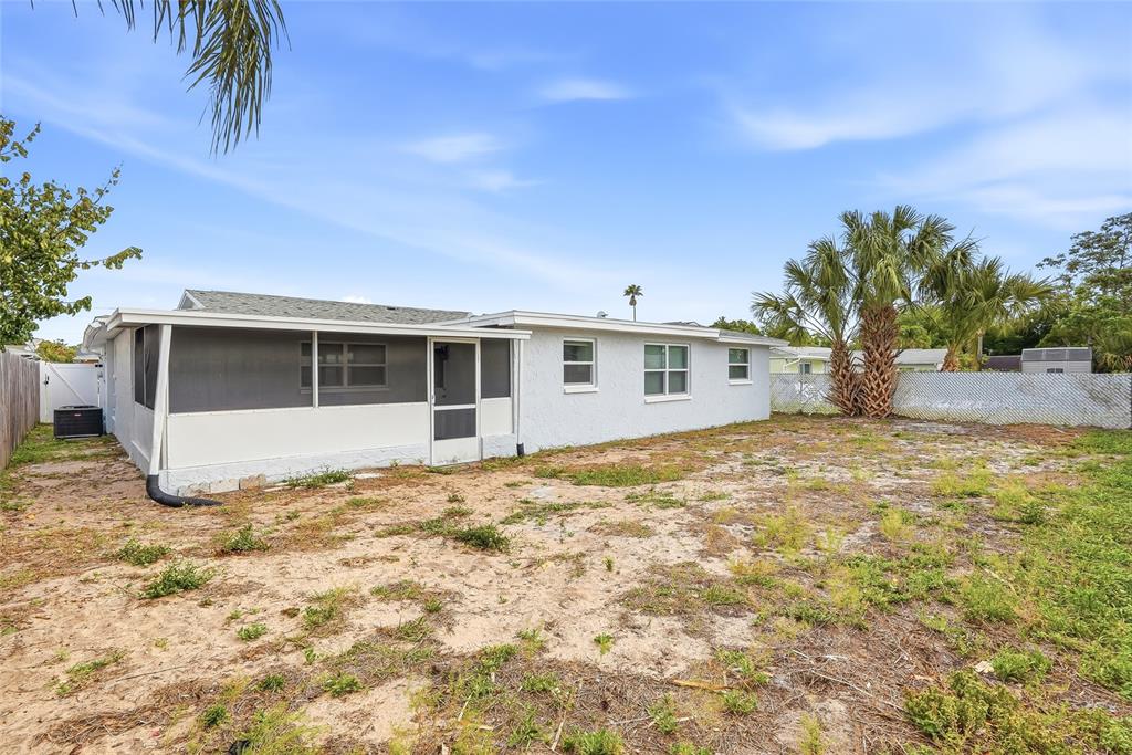6302 Diamond Drive New Port Richey, FL 34653 - Photo 33 of 43 a view of a house with a large window and potted plants