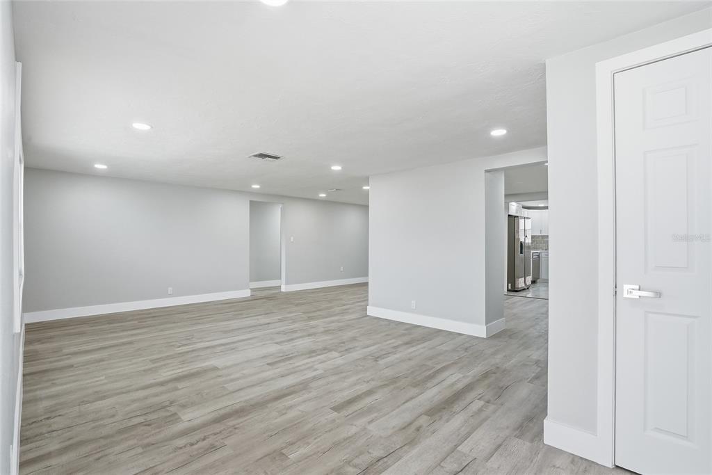 6302 Diamond Drive New Port Richey, FL 34653 - Photo 4 of 43 wooden floor in an empty room with wooden floor