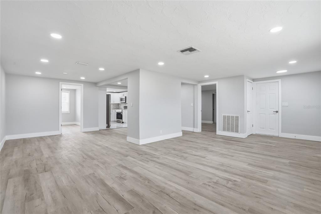 6302 Diamond Drive New Port Richey, FL 34653 - Photo 5 of 43 a view of an empty room with wooden floor and a window