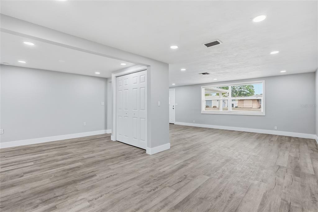 6302 Diamond Drive New Port Richey, FL 34653 - Photo 8 of 43 a view of an empty room with a window and wooden floor