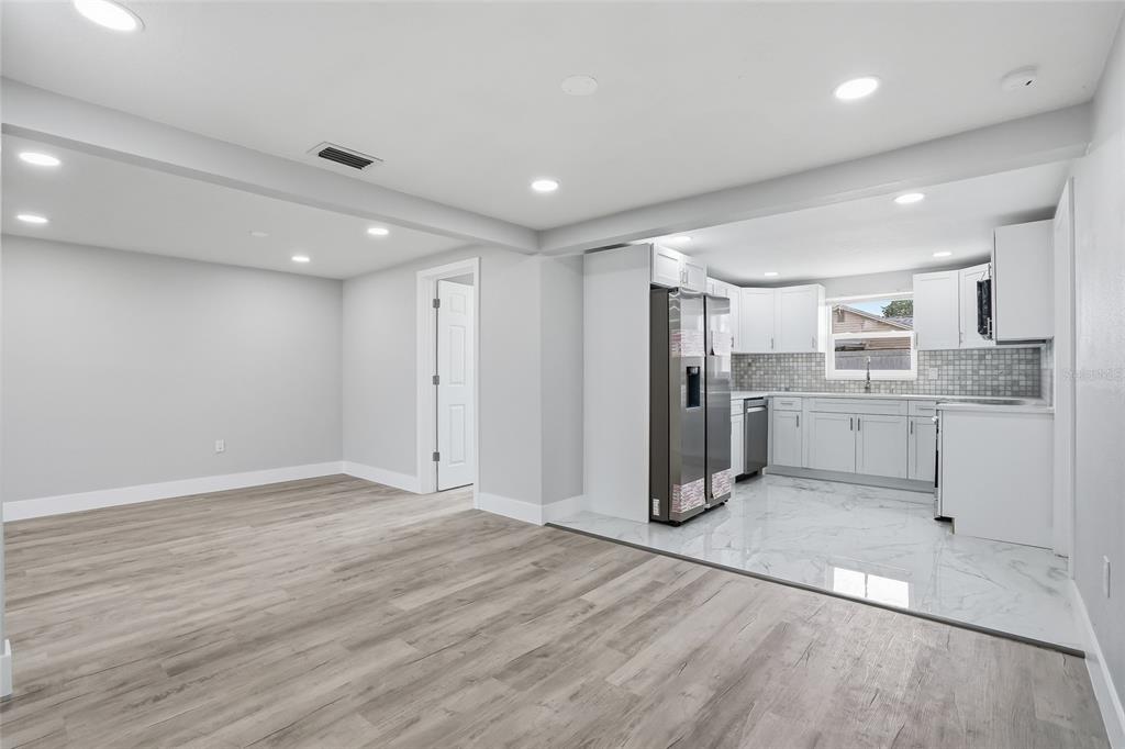 6302 Diamond Drive New Port Richey, FL 34653 - Photo 10 of 43 a view of a kitchen with refrigerator and wooden floor