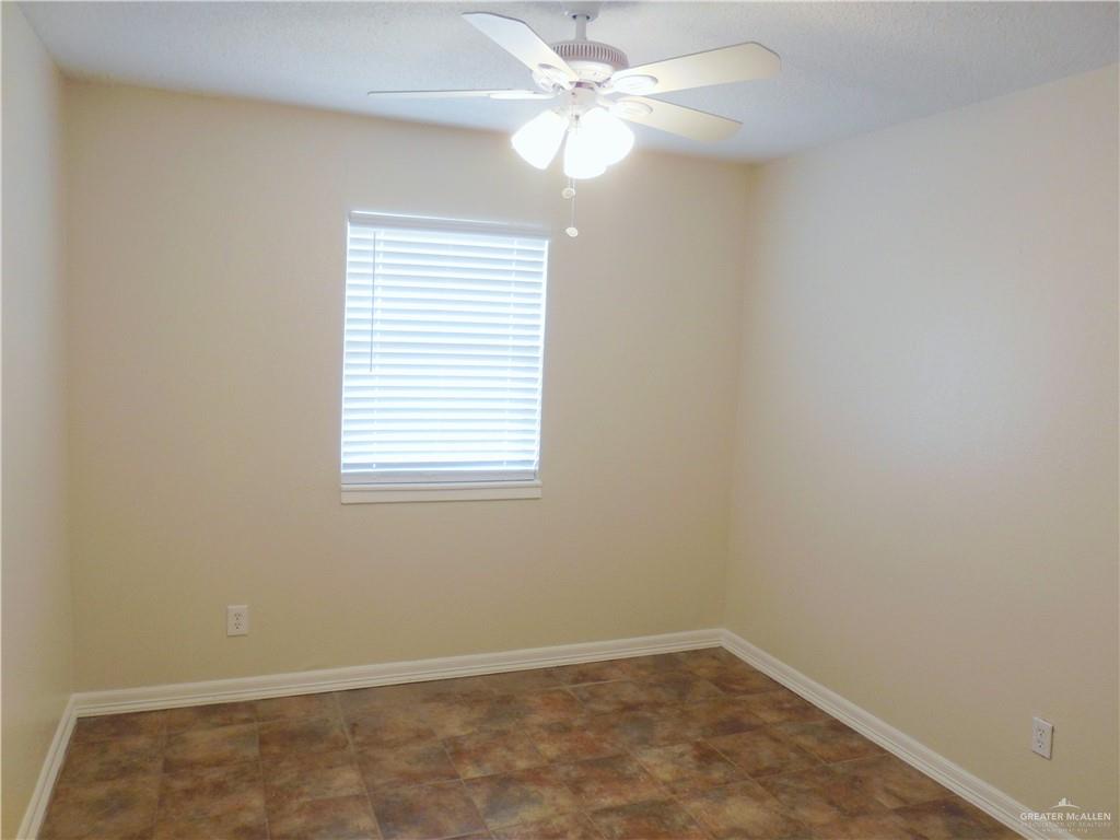 5212-5213 North Taylor Road Mission, TX 78573 - Photo 16 of 20 an empty room with a window and a fan