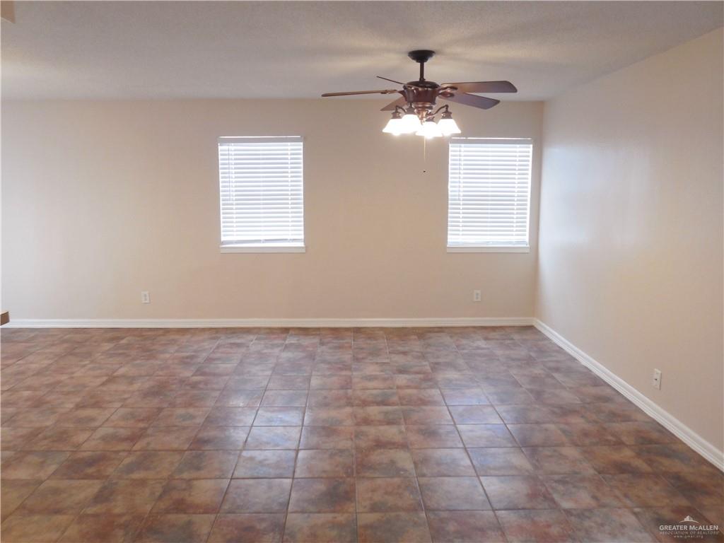 5212-5213 North Taylor Road Mission, TX 78573 - Photo 5 of 20 a view of an empty room with a chandelier fan
