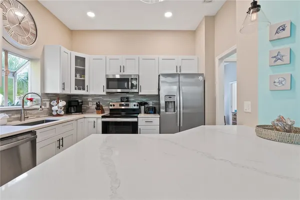 a kitchen with stainless steel appliances a refrigerator stove microwave and sink