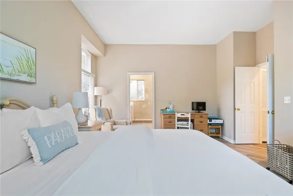 a spacious bedroom with a bed and a window