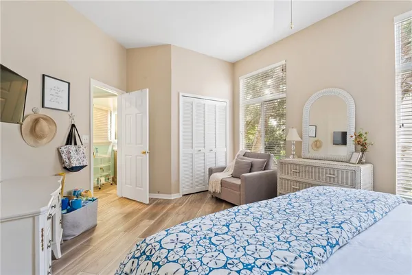 a bedroom with a bed a couch and dresser