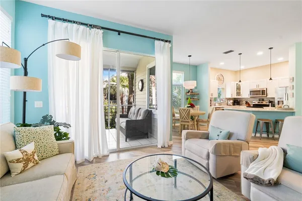 a living room with furniture and a wooden floor