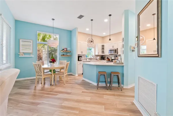 a view of a dining room with furniture and wooden floor