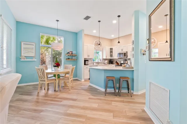 a view of a dining room with furniture and wooden floor