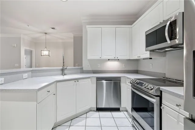 a kitchen with cabinets stainless steel appliances and a sink