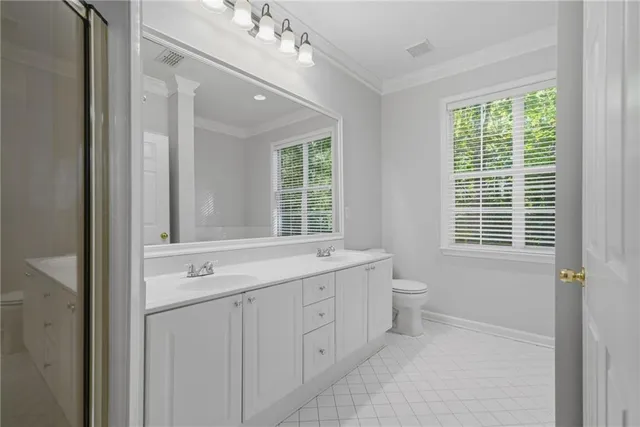 a spacious bathroom with a double vanity sink a large mirror a bathtub and window