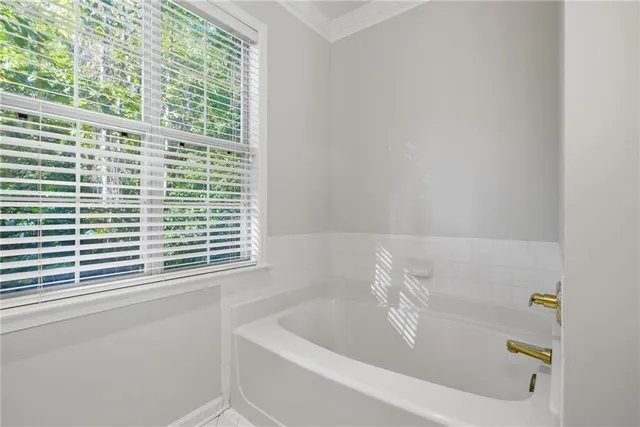 a white bath tub sitting next to a window