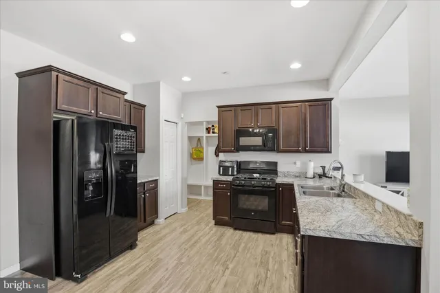 a kitchen with stainless steel appliances granite countertop a refrigerator stove and oven