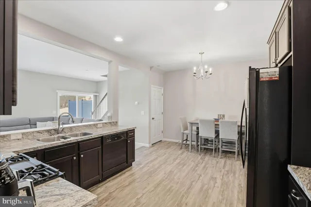 a spacious bathroom with a granite countertop sink a mirror and a bathtub