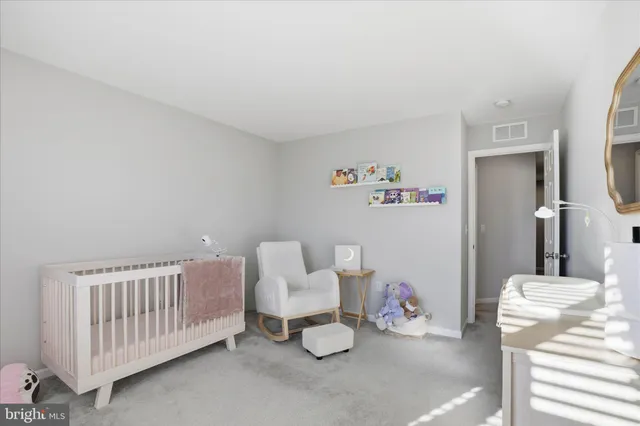 a bedroom with furniture and white walls