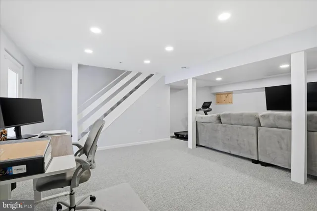 a view of a livingroom with furniture and a flat screen tv
