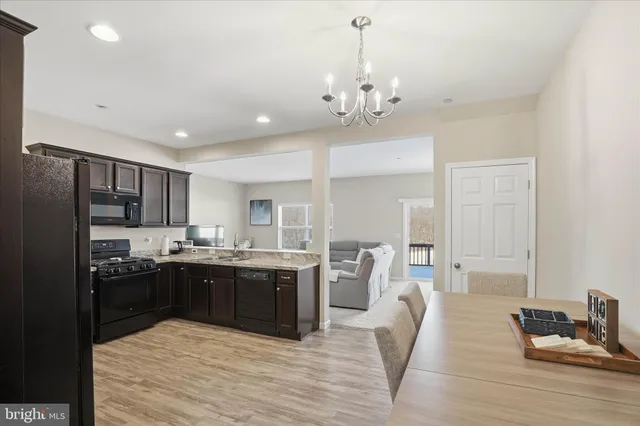 a large kitchen with kitchen island a sink stainless steel appliances and cabinets