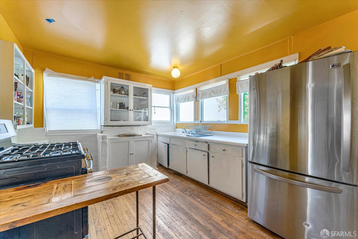 1917 Oregon Street Berkeley, CA 94703 - Photo 15 of 43 a kitchen with a refrigerator and countertop