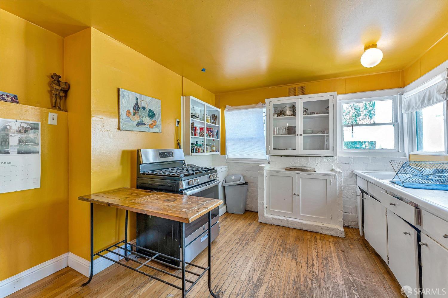 1917 Oregon Street Berkeley, CA 94703 - Photo 18 of 43 a kitchen with stainless steel appliances a stove and wooden floor