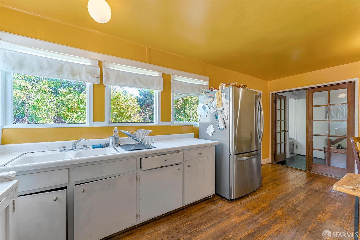 1917 Oregon Street Berkeley, CA 94703 - Photo 19 of 43 a kitchen with appliances cabinets and a large window