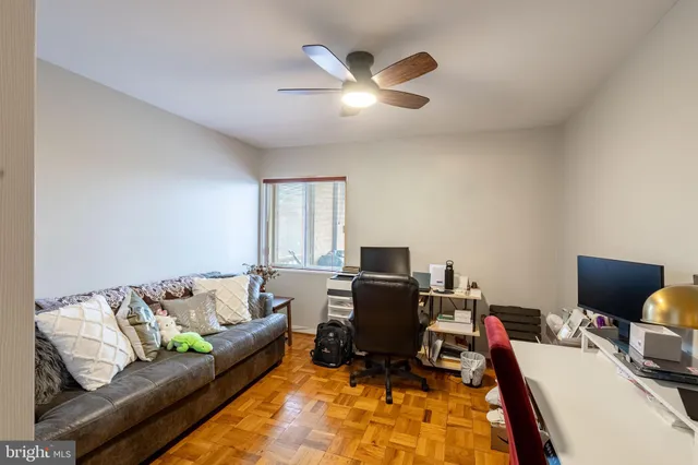 a living room with furniture and a flat screen tv with wooden floor