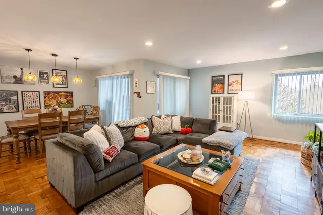 a living room with furniture a rug and a window