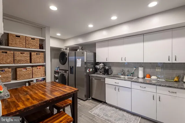 a kitchen with refrigerator and cabinets
