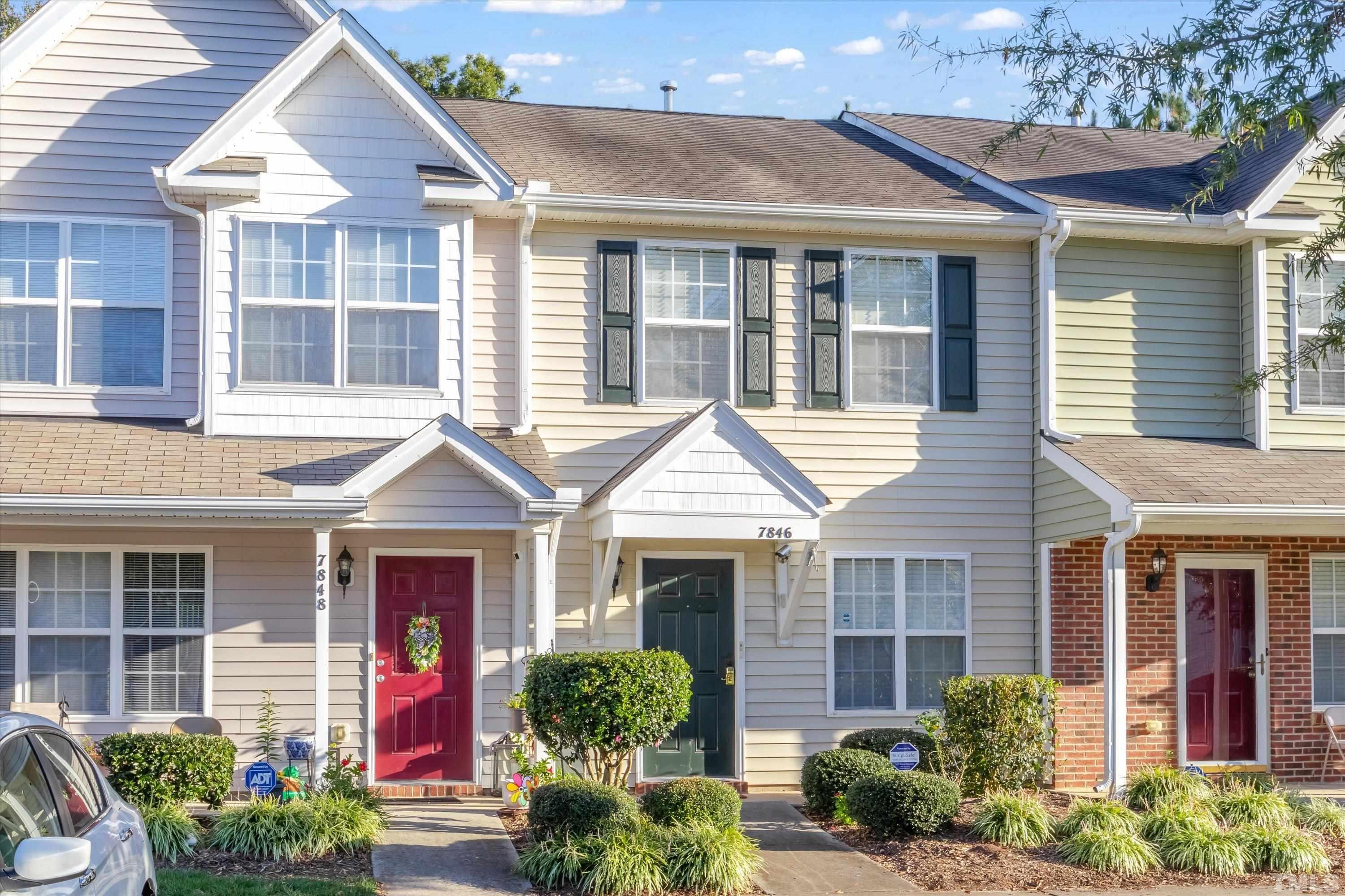 7846 Averette Field Drive Raleigh, NC 27616 - Photo 1 of 21 a front view of a house with a yard and potted plants