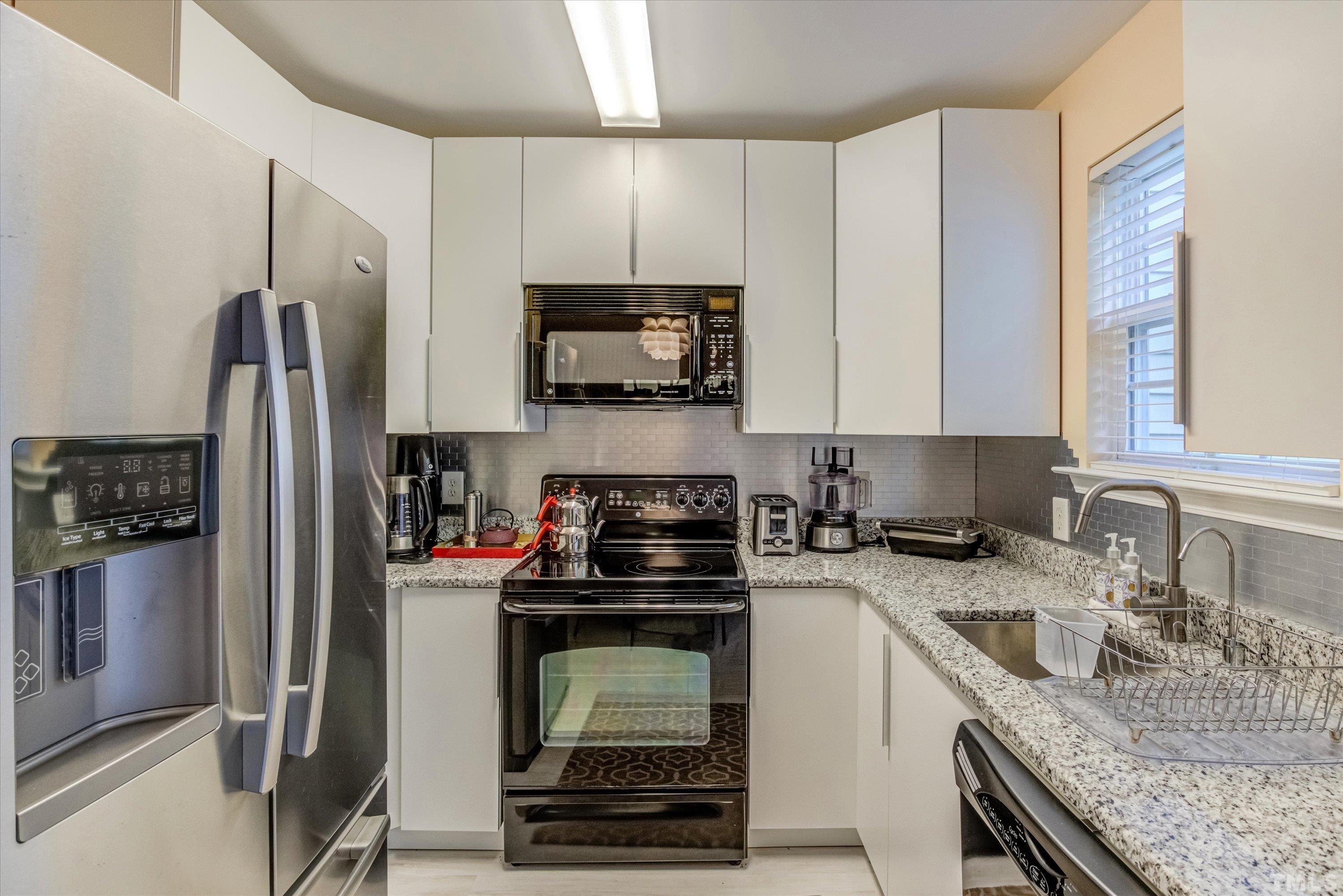 7846 Averette Field Drive Raleigh, NC 27616 - Photo 6 of 21 a kitchen with a sink stove and refrigerator