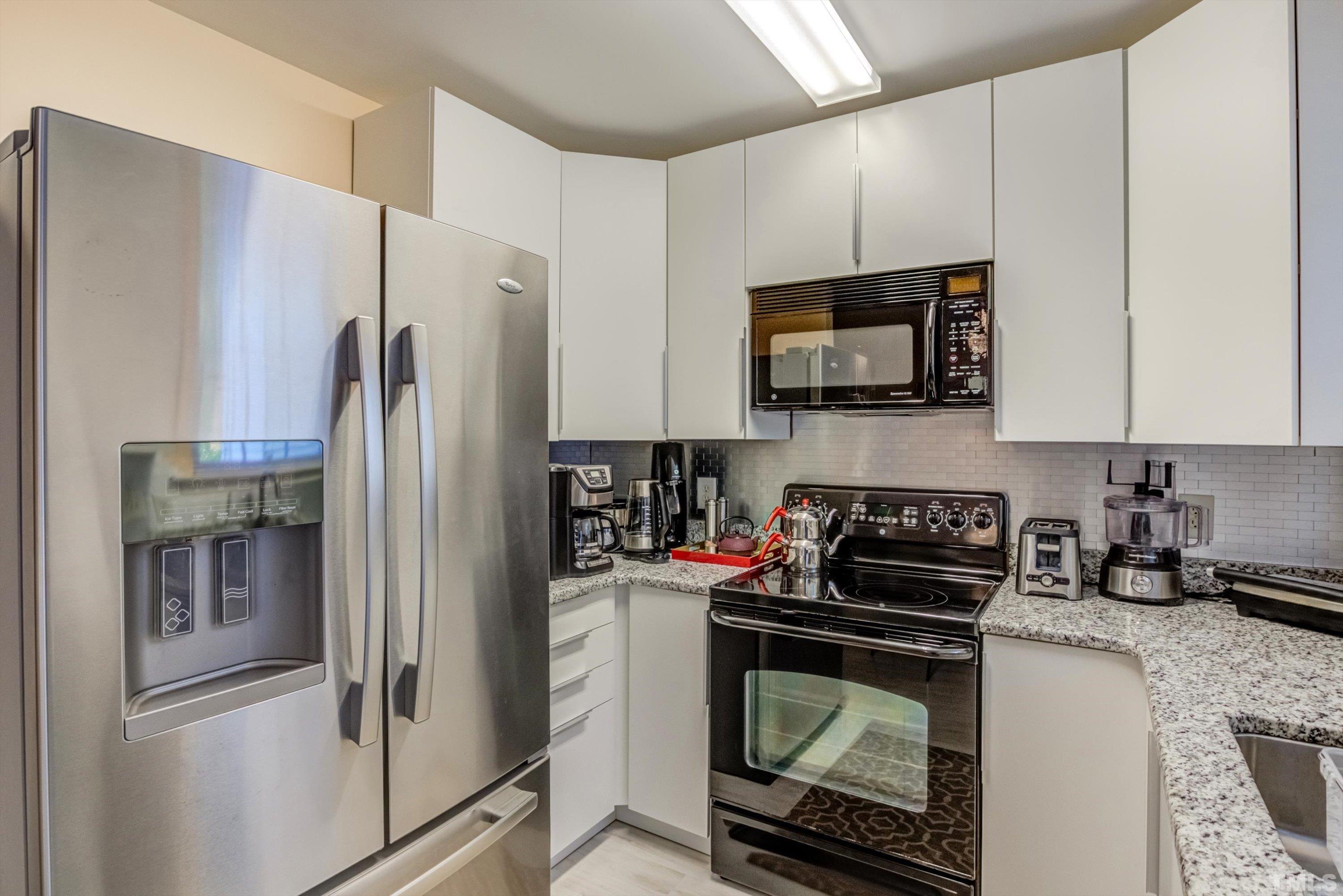 7846 Averette Field Drive Raleigh, NC 27616 - Photo 8 of 21 a kitchen with a refrigerator stove and microwave