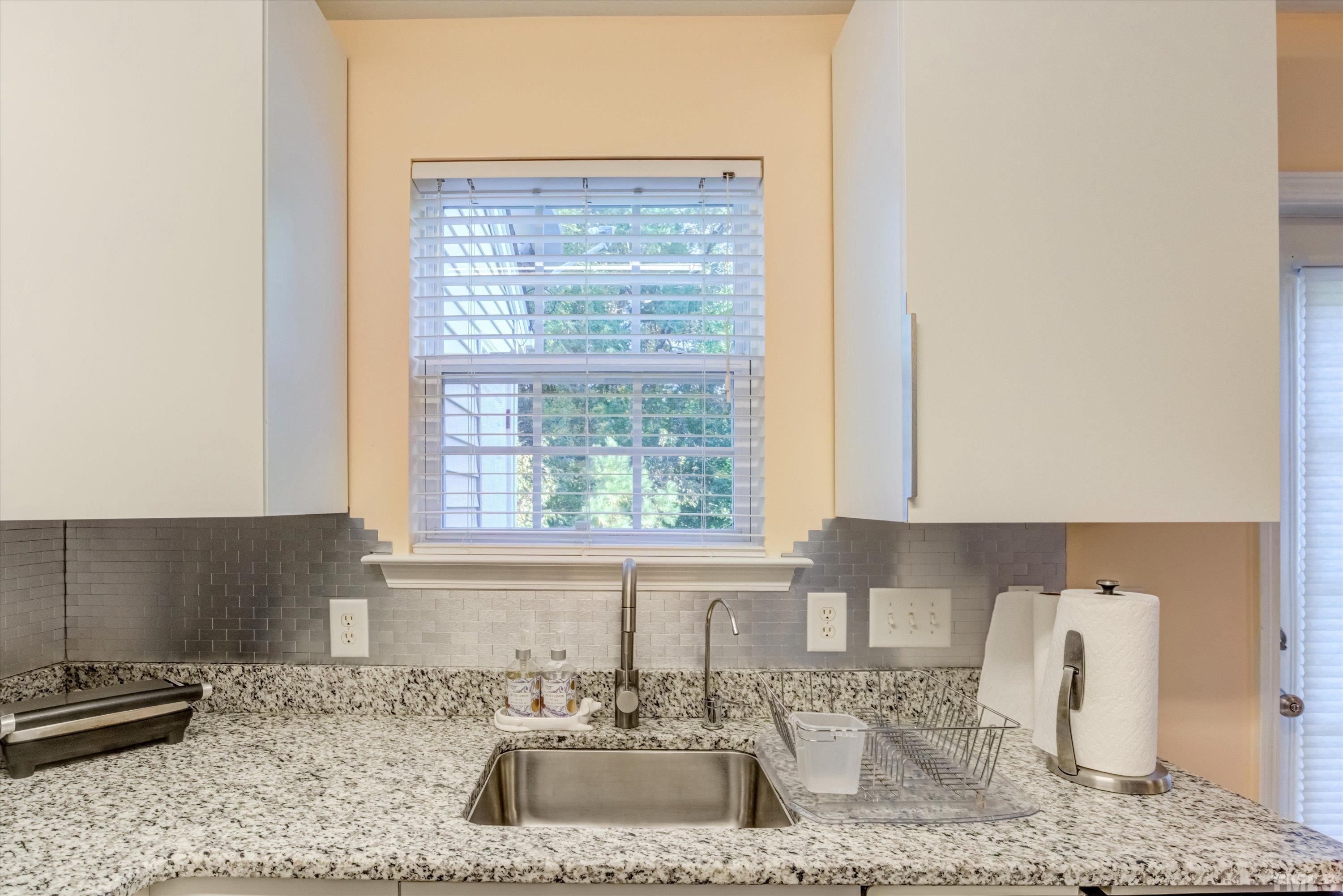 7846 Averette Field Drive Raleigh, NC 27616 - Photo 9 of 21 a kitchen with a sink cabinets and a window